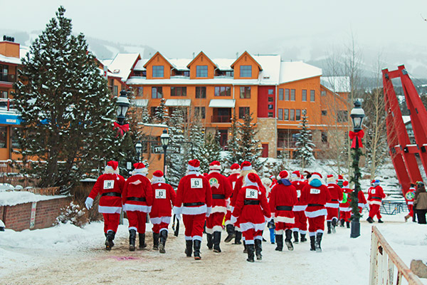 A group of Santas walking in downtown Breckenridge on a winter day.