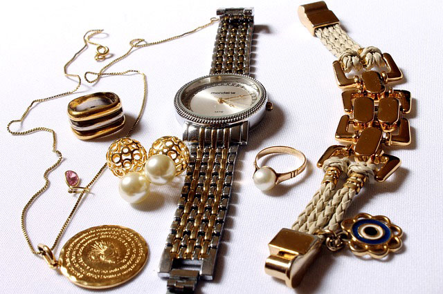 A picture showing a necklace, bracelet, watch, earrings, a ring and a pair of cufflinks.