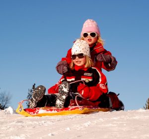 Two children on a sled.